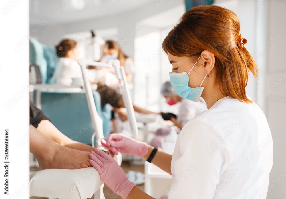 Obraz premium Two girlfriends, pedicure process in beauty salon