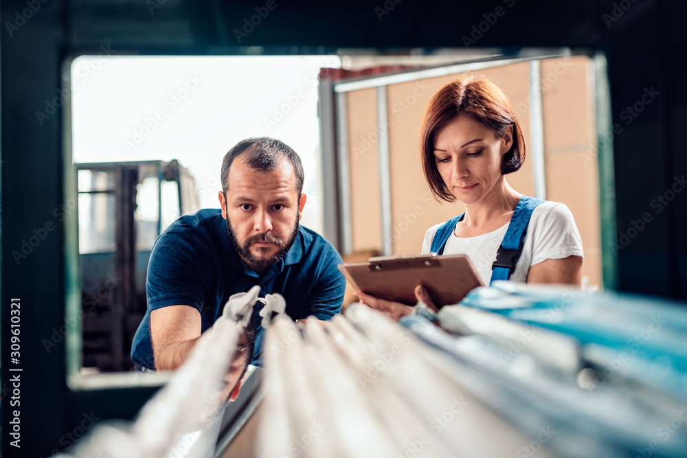 Stock clerk checking warehouse inventory Stock clerk checking warehouse inventory