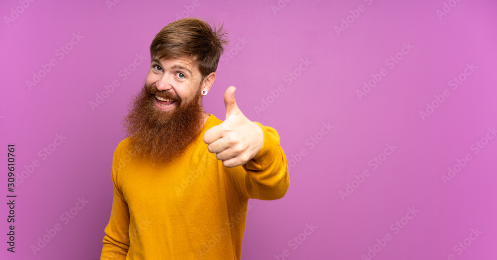 Redhead man with long beard over isolated purple background with thumbs up because something good has happened Redhead man with long beard over isolated purple background with thumbs up because something good has happened