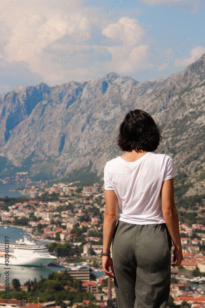 Naklejka premium girl looks at the bay. Montenegro