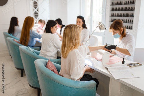 Group of girlfriends, manicure in beauty salon