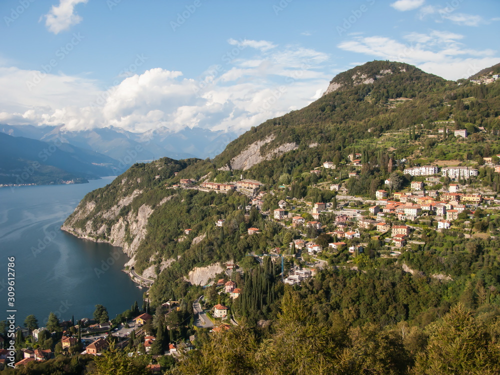 panoramic view of forest, mountains and blue sky from tower of Castello di Vezio, Varenna, Como lake, Lombardy, Italy