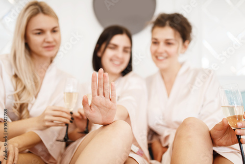 Group of girlfriends with champagne, beauty salon