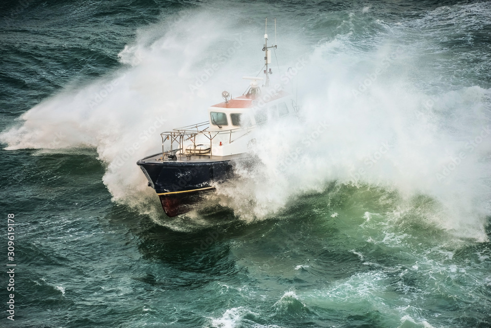 Fototapeta premium incredible view of a pilot boat in the storm