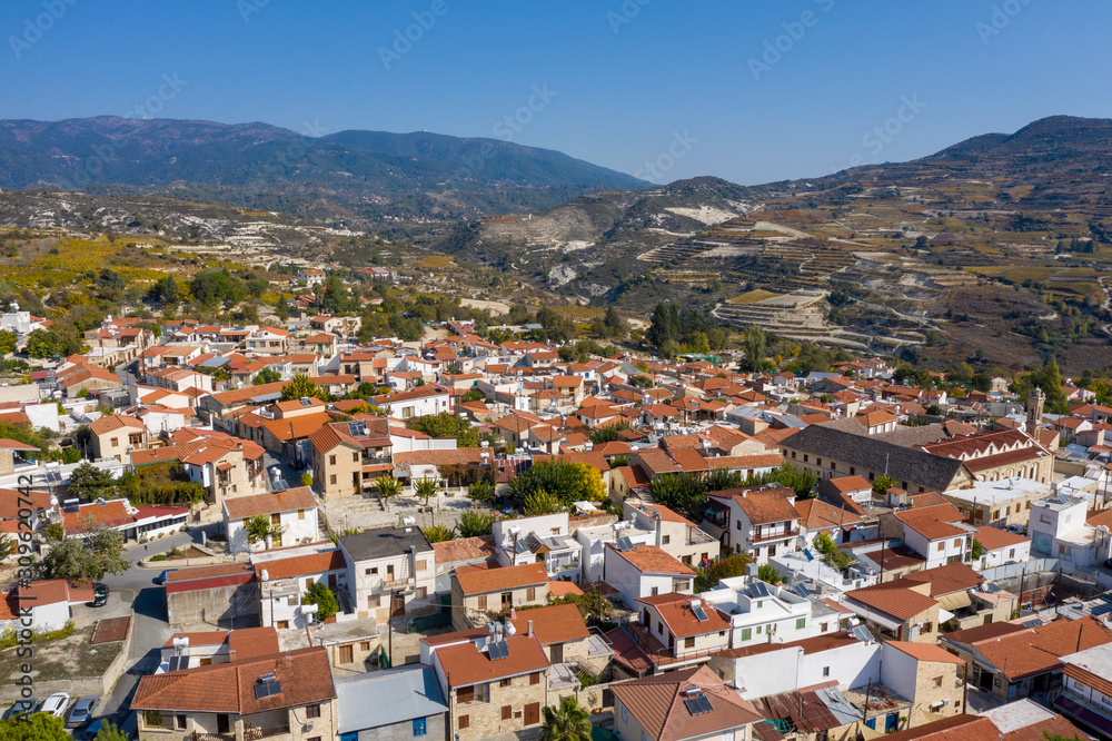 Aerial view of Omodos⁩, ⁨Limassol⁩, ⁨Cyprus⁩. Beautiful houses with red roofs. Mountains in the background