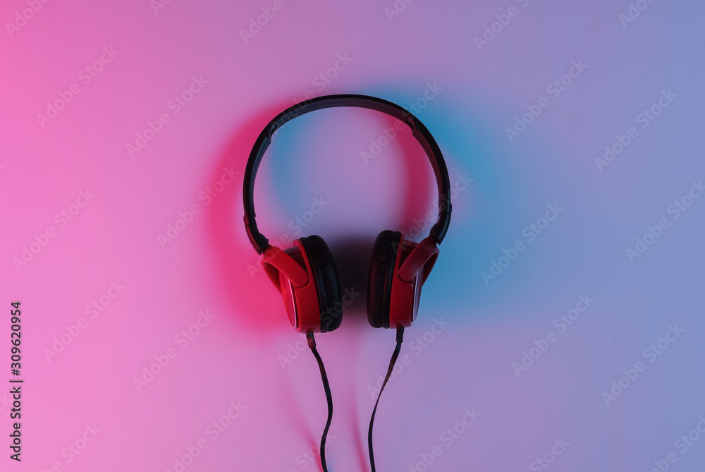 Wired headphones with neon blue-red gradient light. Retro wave, 80s pop  culture. Top view Stock Photo | Adobe Stock
