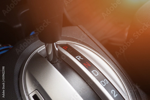 Closeup of automatic transmission in the car for modern design and interior. Gear stick and car equipment and transportation for safety driving concept photo