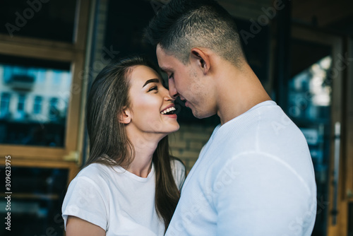 Happy couple in love talking about leisure and laughing from jokes togetherness enjoying free time outdoors, positive Caucasian man and woman feeling excited from rejoices at public place