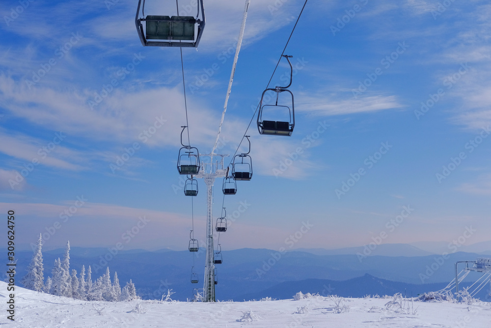Funicular for tourists, skiers and snowboarders. lift to transport people in the mountains. the cable car on the background of blue mountains. funicular in the mountains