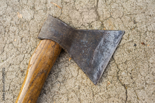 old ax lying on the pavement