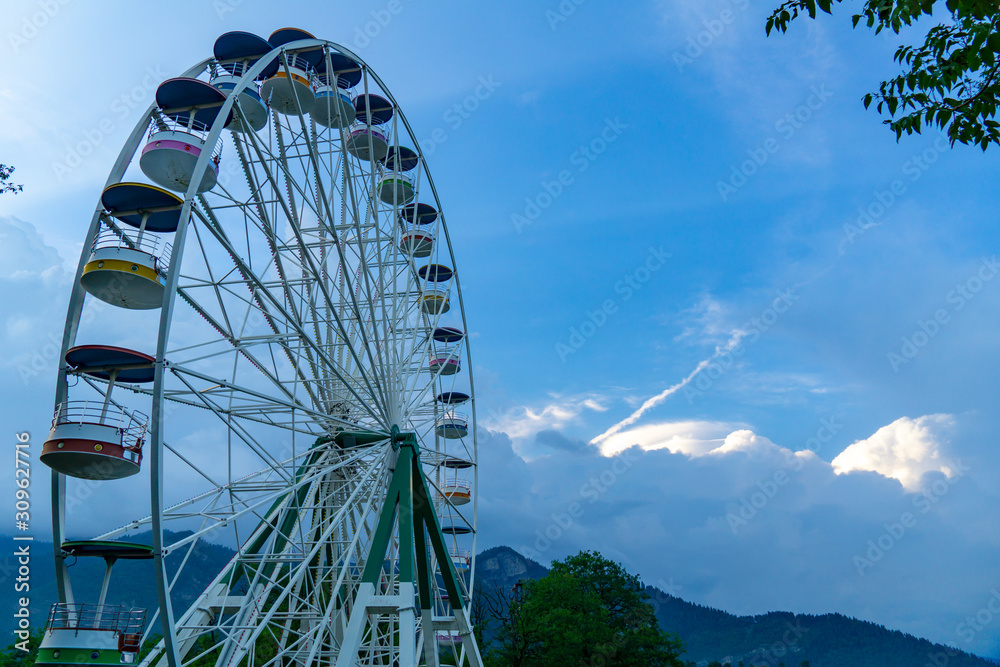 Brightly colored Ferris wheel blue sky