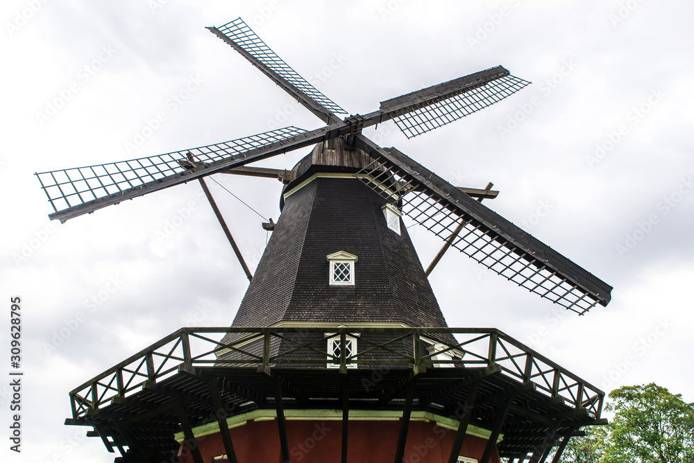 Old windmill on a green lawn in the summer in a Park in Copenhagen