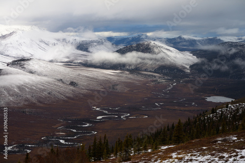 View of snow on Endicott Mountains Alaska with Wiseman Creek valley and Nolan Creek Lake