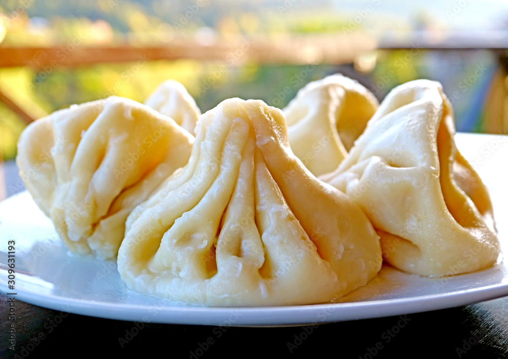 Closeup the Famous Georgian Soup Dumplings Called Khinkali on a White Plate