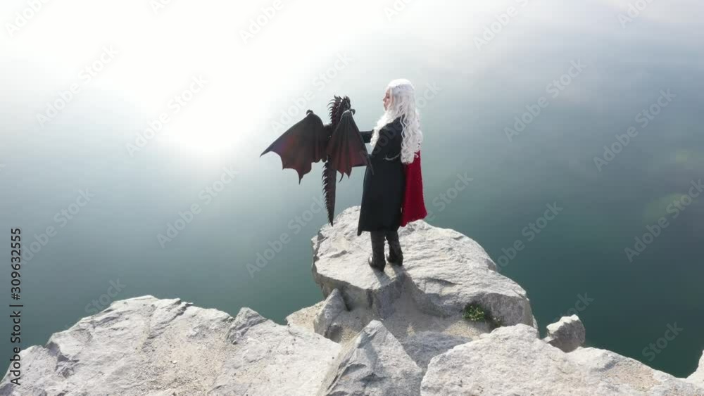 Beautiful girl in a blonde wig and a fantasy costume. Mother of dragons.