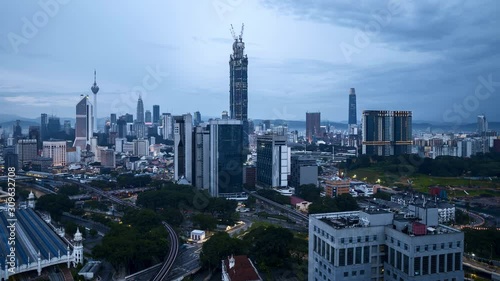 Time lapse of cloudy sunset day to night at Kuala Lumpur main transportation hub, KL Sentral. Tilt up photo