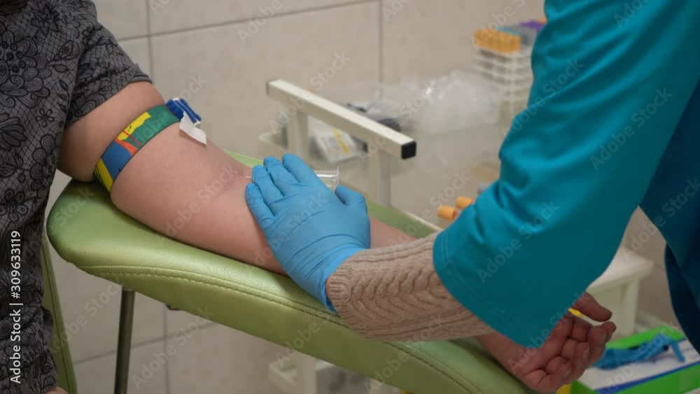 A teenage girl gives blood for analysis. Blood sampling from a vein. A teenage girl gives blood for analysis. Blood sampling from a vein.