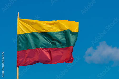 The flag of Lithuania flying in breeze wind on sky background