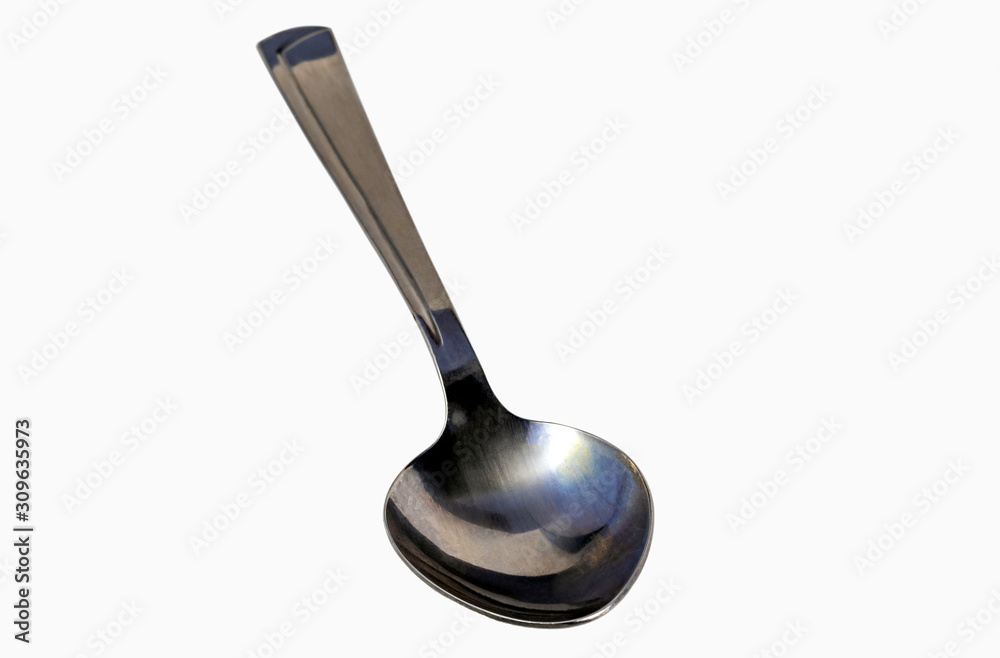 close-up. empty steel spoon on a white background. insulation. close-up. empty steel spoon on a white background. insulation.