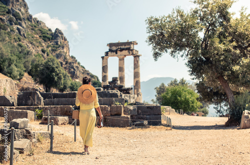 Papier peint Young woman tourist at Sanctuary of Athena, Delphi Greece