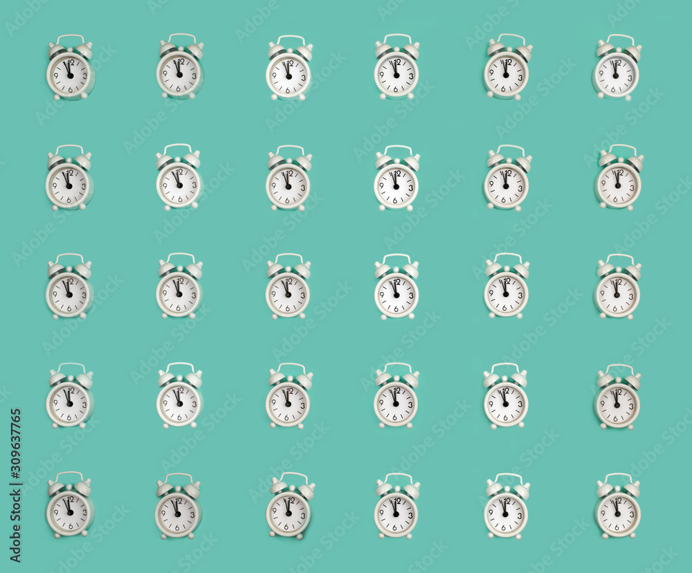Summer sunlight pattern made with a white clock on a bright green background. The concept of minimum time. Summer sunlight pattern made with a white clock on a bright green background. The concept of minimum time.