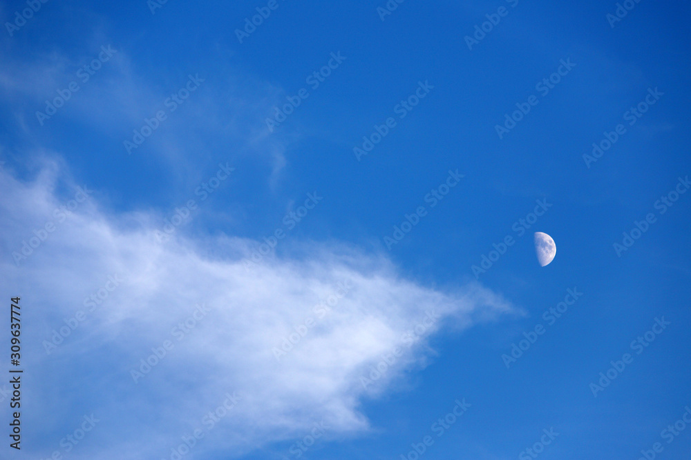 Crescent a day in blue sky, white clouds. Crescent a day in blue sky, white clouds.