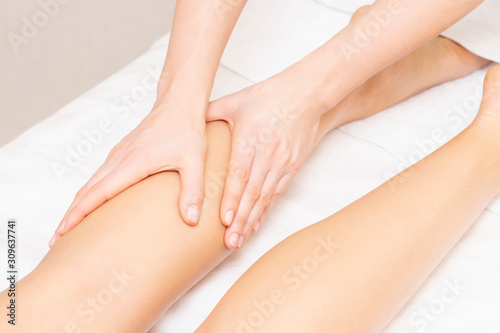 Fototapeta Naklejka Na Ścianę i Meble -  Young woman having feet massage in beauty salon, close up view