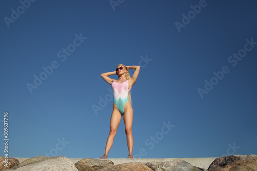 Young blonde with a beautiful athletic body in a swimsuit