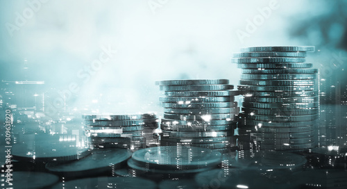 Double exposure of city and stack of coins for finance and banking concept