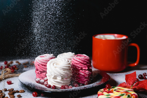 Handmade air russian fruit pink and white marshmallow on a black background. Homemade Sweets.