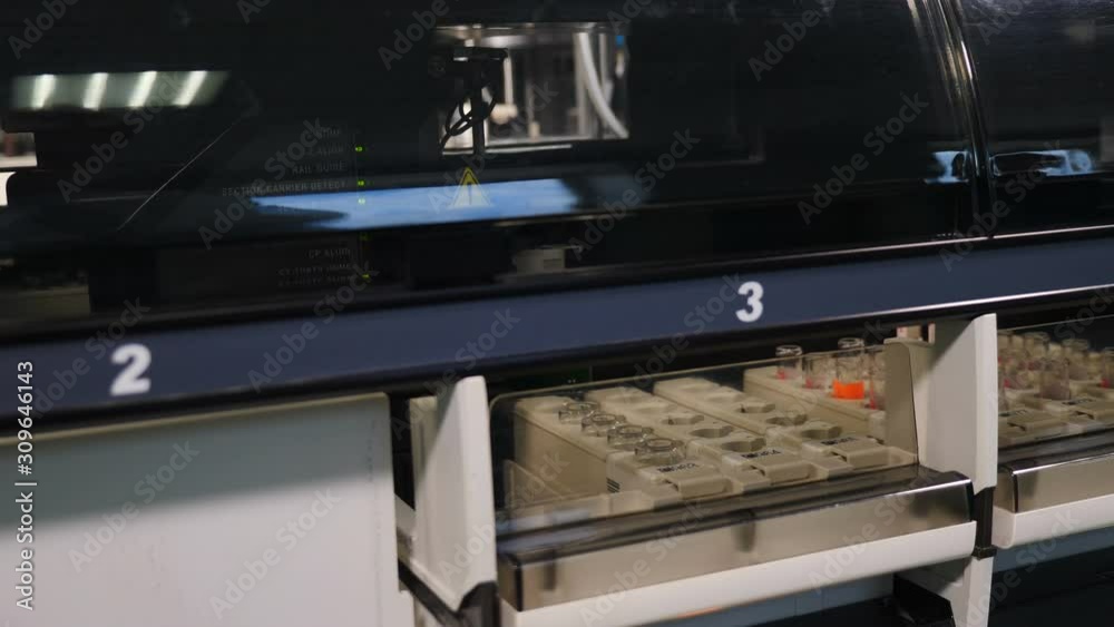 blood samples in rack in automated machine for human dna or blood analysis, concept of laboratory equipment. Shot in 4k blood samples in rack in automated machine for human dna or blood analysis, concept of laboratory equipment. Shot in 4k