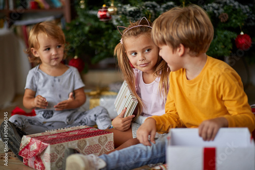  children with Christmas presents. kids open present.