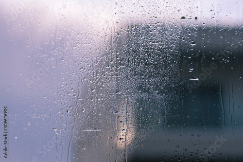 Window glass with drops and silhouettes