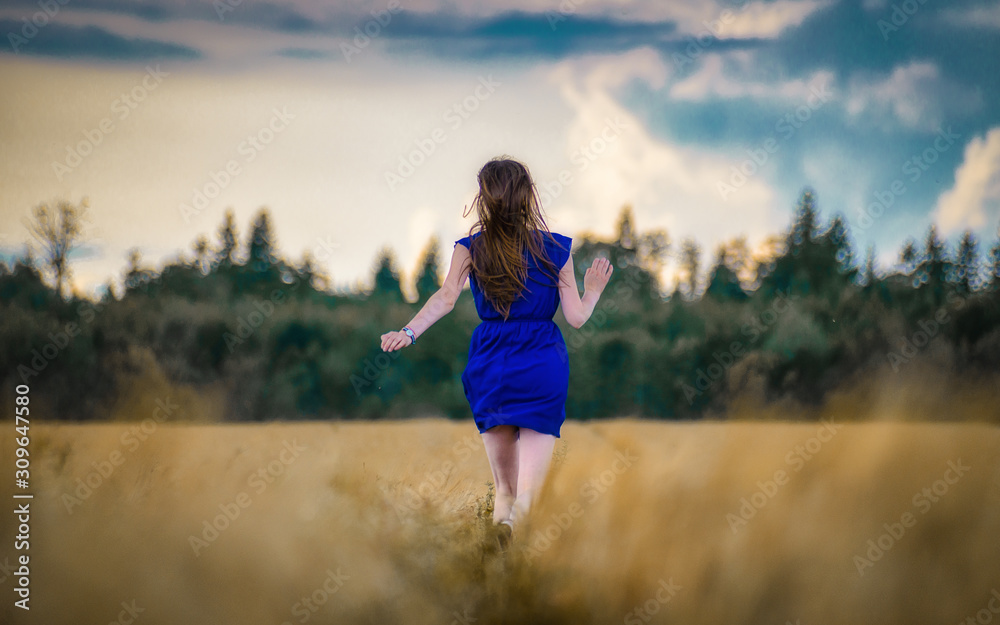 young woman running in the field young woman running in the field