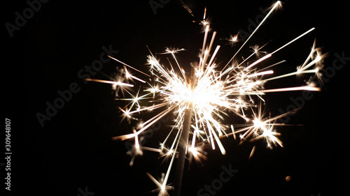 Close-up of firework sparkler burning. Fireworks burn on a black background