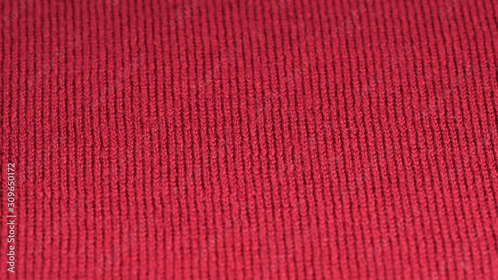 Red wool fabric plain surface background. Woolen textile texture tracking, low angle. Slider shot. Focus at center. 4K 422 10 bit