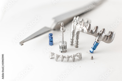 Close-up studio shot on milled metal frame for dental implants on the white background. Concept of new technologies in dental prosthetics photo