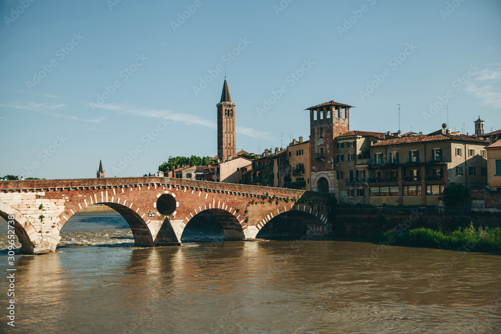 Beautiful view of traditional architecture and a bridge over a river in Verona in Italy.