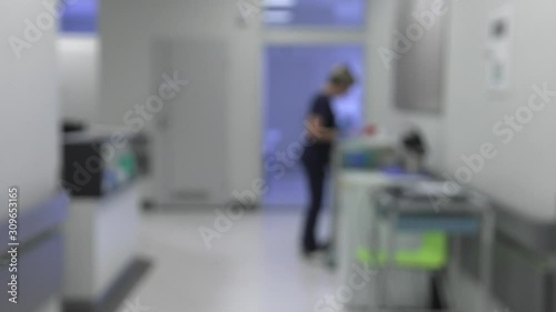 Doctors, nurses, patients and other employees walk around the hospital ward. Blurred shot. BLUR. 4K, UHD, 50p, Cinematic,Panning,						