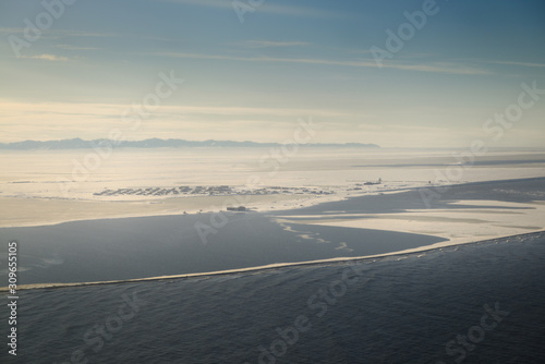 Aerial view of Eskimo village of Kaktovik Alaska on the Arctic Ocean with Brooks Range mountains