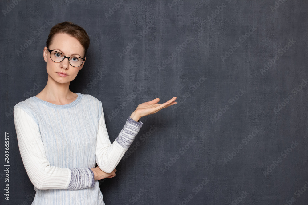 Portrait of serious focused girl pointing at copy space on right Portrait of serious focused girl pointing at copy space on right