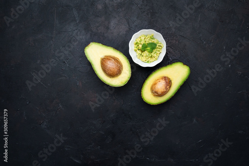 Avocados cut in halves with guacamole. Healthy food.