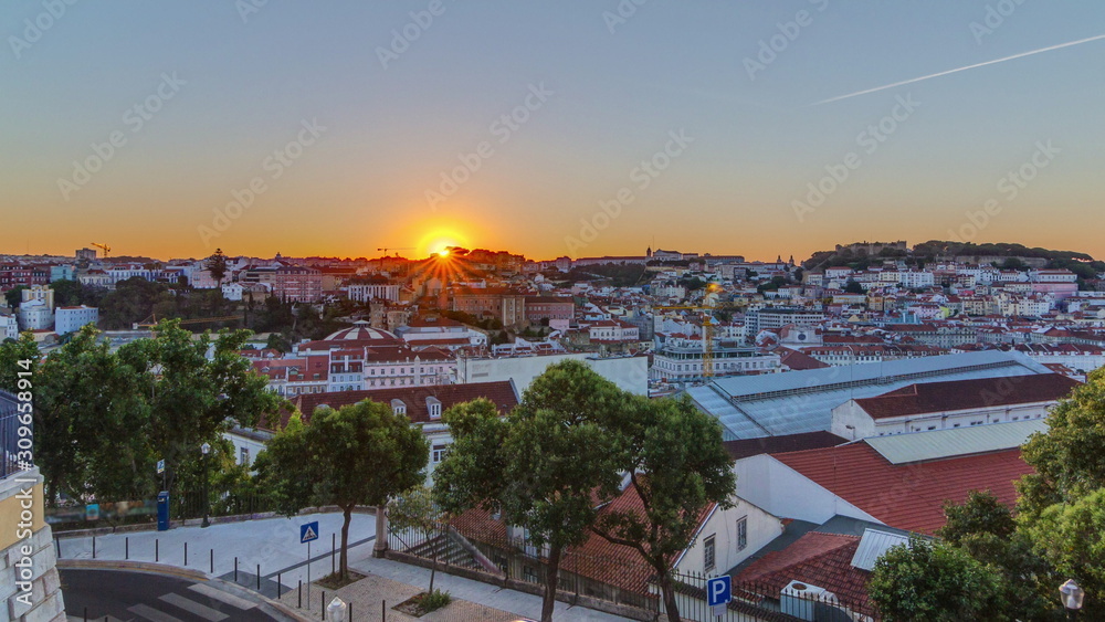 Sunrise over Lisbon aerial cityscape skyline timelapse from viewpoint of St. Peter of Alcantara, Portugal.