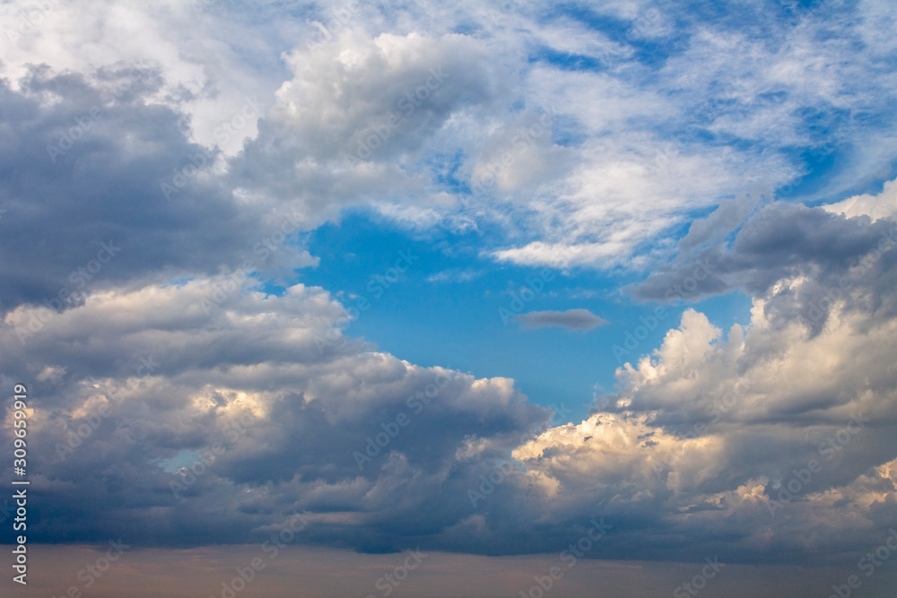 the sun shining through the clouds against the blue sky, light clouds in the sky