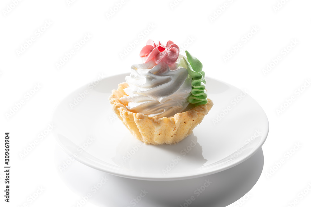 Tart cake with whipped cream, isolated on a white plate Tart cake with whipped cream, isolated on a white plate