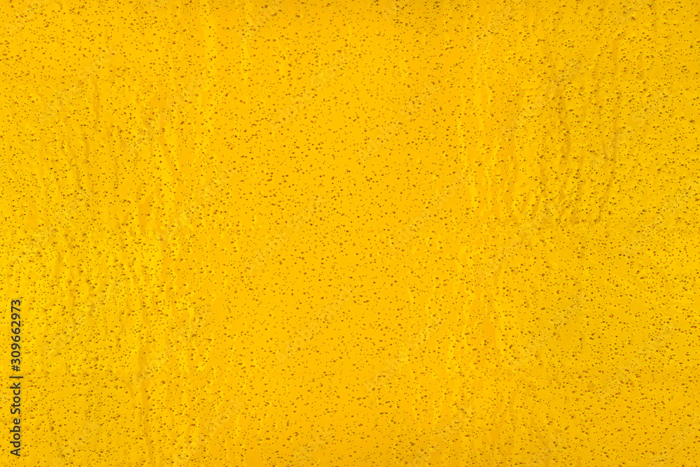 Real texture of yellow, rough material with small holes, illuminated with light. Real texture of yellow, rough material with small holes, illuminated with light.