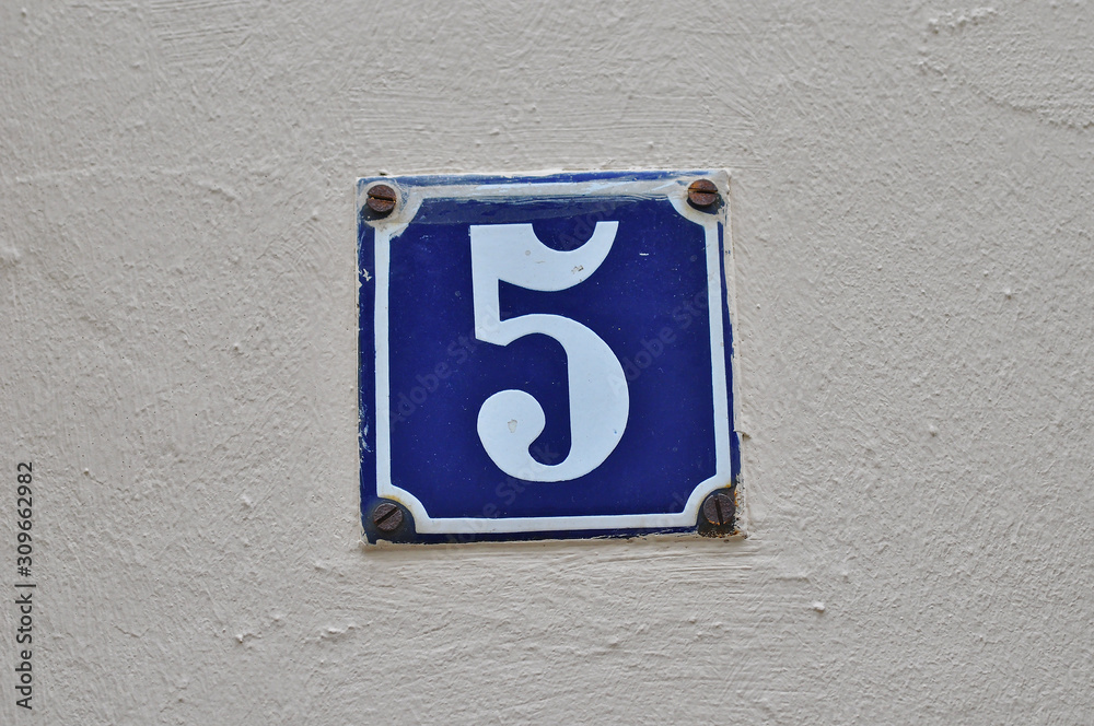 A house number plaque, showing the number five (5) A house number plaque, showing the number five (5)