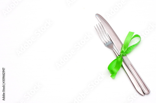 fork and knife on a white table.