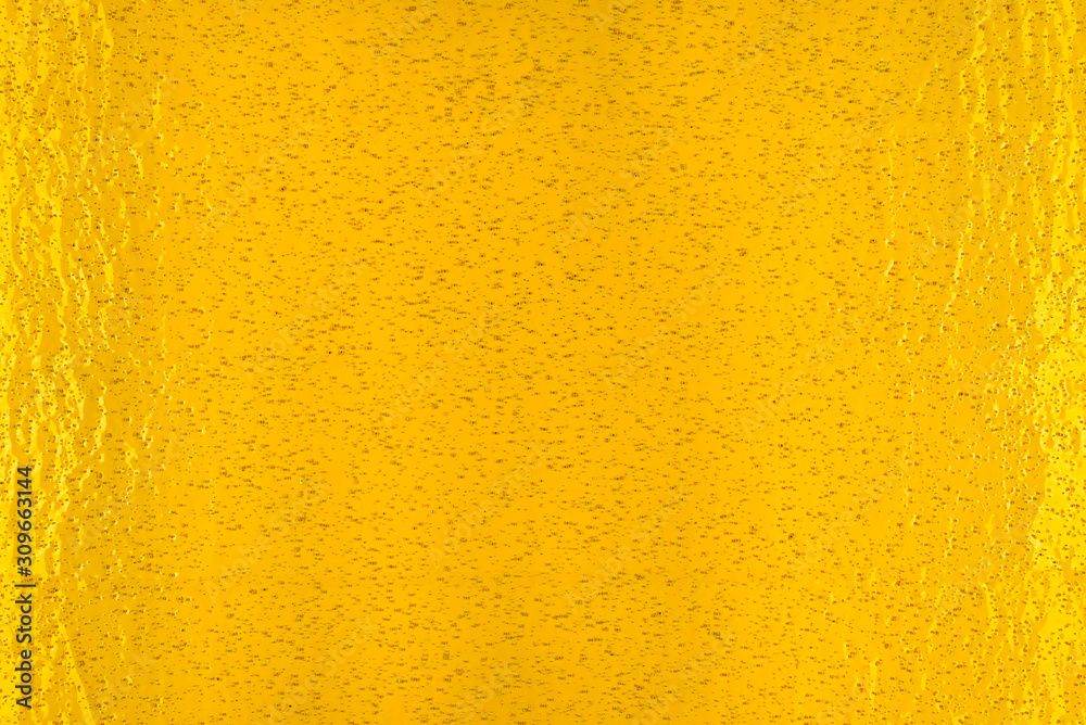 Fototapeta premium Real texture of yellow, rough material with small holes, illuminated with light.