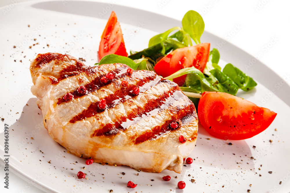 Grilled steak with vegetable salad on white background Grilled steak with vegetable salad on white background